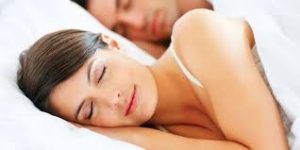 women sleeping on bed pillow from sleep apnea dental treatment